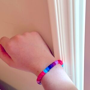 Homemade bracelet w/ colors in a ombre pattern and another w/ purple and silver.